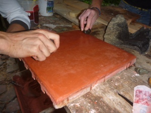 Burnishing the plaster with stones for its polished finish
